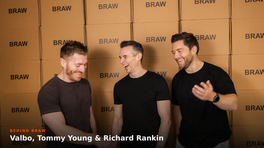 BRAW founders Valbo, Tommy Young and Richard Rankin laughing in front of a wall of BRAW boxes